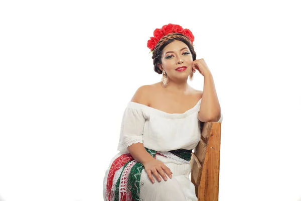 Mexican woman made up with the colors of the Mexican flag. Portrait of woman seated with makeup with the colors of the flag of Mexico.