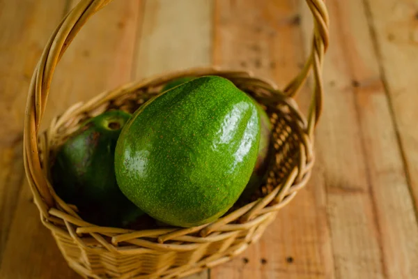 Basket Avocados Wooden Table — 스톡 사진