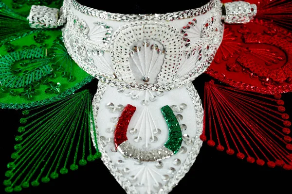 Mexican charro hat in the foreground. Typical mexican hat with the colors of the mexican flag.