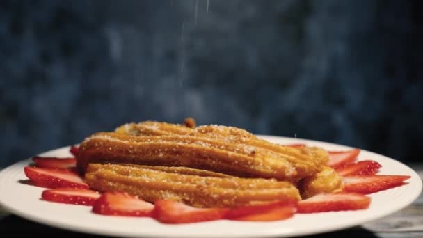 Churros Rotating White Plate Decorated Strawberries Foreground — Stock Video