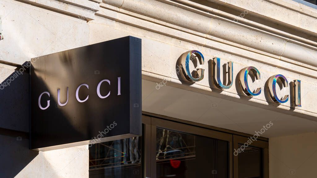Paris, France - February 9, 2022: Sign of a Gucci store, an Italian brand originating from Florence in Italy specializing in fashion and luxury, and currently a subsidiary of the Kering group