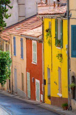 Colorful facades of ancient houses in a street in the old town of Hyeres, France, in the French department of Var