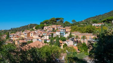 Distant view of the old village of Bormes-les-Mimosas, France, located on the French Riviera (Cote d'Azur), in the French department of Var