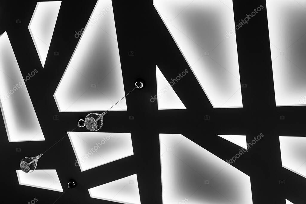 modern ceiling with lighting and lamps with abstract design black and white photo