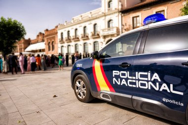Police car with crowd in the background