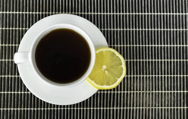 Black coffee with lemon slices, on an old dust filter, romantic in morning.