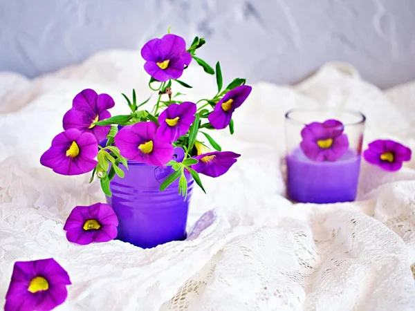 Violet-purple flowers in purple pot basket for background embroidered cloth Calibrachoa petunia Million bells ,Trailing petunia ,Superbells ,seashore smaller flowers ,Solanaceae ,still life creative
