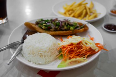 Fish salad and carrot mayonnaise with jasmine rice in white place on dining table. food asian for health concept.
