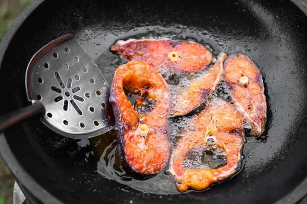锅里的炸鱼 生鱼片煎与非常热的植物油在黑锅里 早上在厨房里做饭 亚洲传统食物和主食泰国牛排早餐 — 图库照片