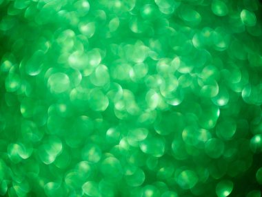 Blur green glitter abstract background. pattern texture bokeh bright glowing glisten color christmas backdrop. shimmer wrapping card poster for happy new year 2023 celebration party holidays concept.