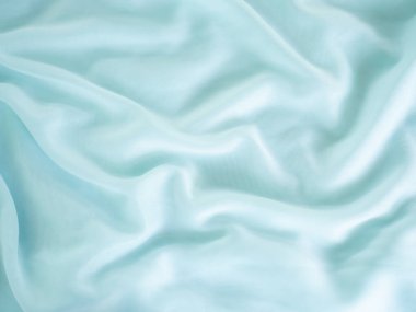 Blue fabric linen background.texture wave surface cotton fashion backdrop. luxury display silk cloth free space for add text or products presentation. soft smooth satin wallpaper pattern design.