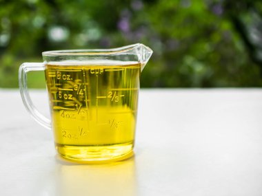 Rice Bran Oil in Glass on white table and nature background.Organic vegetable oil pure Homemade and not processed.Raw food ingredient Cooking natural for Good Health.low calories and antioxidant