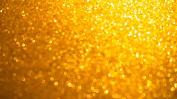 Gold Orange Blur Glitter Effect Bokeh Light Background,Abstract Overlay Dark Texture Spark Backdrop for Party Christmas in Night,Defocused Sparkle Glow Pattern Design Decoration Happy New Year2023.