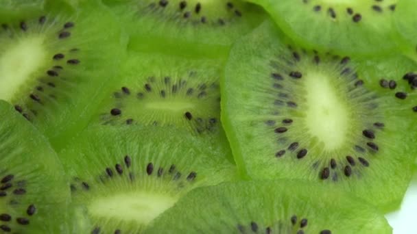 Fondo en forma de tiradas de kiwi en rodajas, fruta de kiwi verde jugosa o grosella china — Vídeo de stock