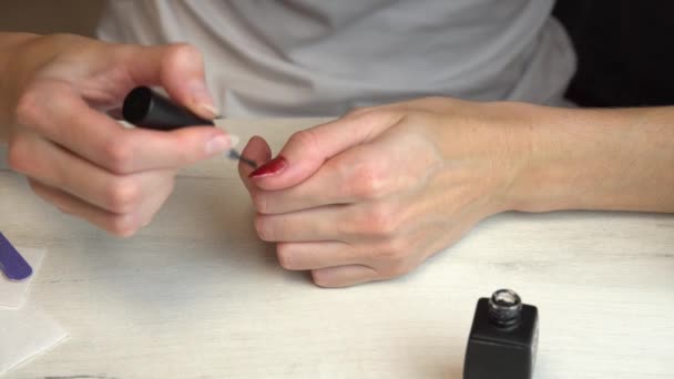 La ragazza applica due strati di smalto sulle unghie, auto manicure, manicure a casa — Video Stock