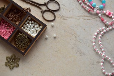 Mücevherleri yapıyorum. Bilezik yapmak için dikiş aksesuarları, boncuklardan zincir. DIY projesi. Küçük bir iş. Hobiden gelir..