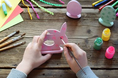 Paskalya dekorasyon - Paskalya yumurtaları ve tavşan yapma. Boyama ve Fırçalar ve guaj ahşap oyuncak boyama. Yaratıcı süreç. Çocuk DIY kavramı.