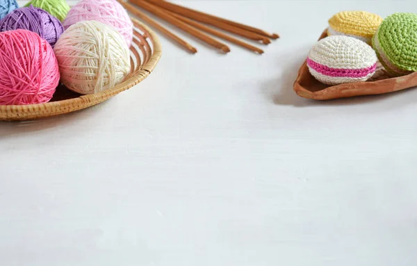 Crochet amigurumi french macarons. Toy for babies or trinket.  Threads, needles, hook, cotton yarn. Handmade gift. Income from hobby. DIY crafts concept.