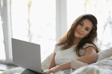 Evdeki en sevdiğiniz kanepeden bir dizüstü bilgisayarda uzaktan çalışma.