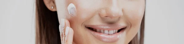 Woman Smiles Shows Even White Teeth Apply Face Cream — Stock Photo, Image