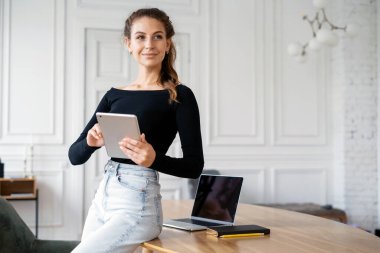 Finansör müşterilerin e-postalarına cevap verir. Birlikte çalışma bürosu. Ev işyerinde serbest çalışan bir kadının portresi. Tasarımcı internette bir aletle sörf yapıyor..
