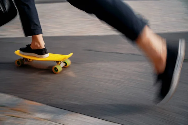 A blurry photo in motion. An entrepreneur rides a skateboard to work in the morning. The lawyer holds a bag with documents in his hand. The manager is rushing to a meeting in a business suit.