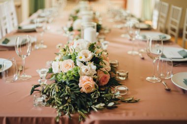 Wedding table decorations in light peach color. Romantic wedding in a villa on Lake Como clipart