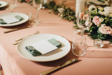 Wedding table setting with a place cards in light peach color. Romantic wedding in a villa on Lake Como