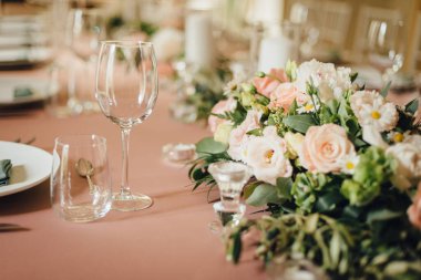 Wedding table decorations in light peach color. Romantic wedding in a villa on Lake Como