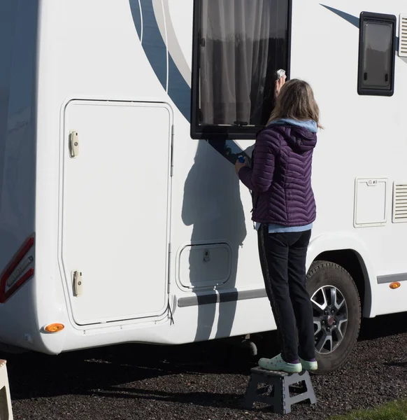 Lady Motorhome Owner Cleans Her Recreational Vehicle Window She Stands Stock Image