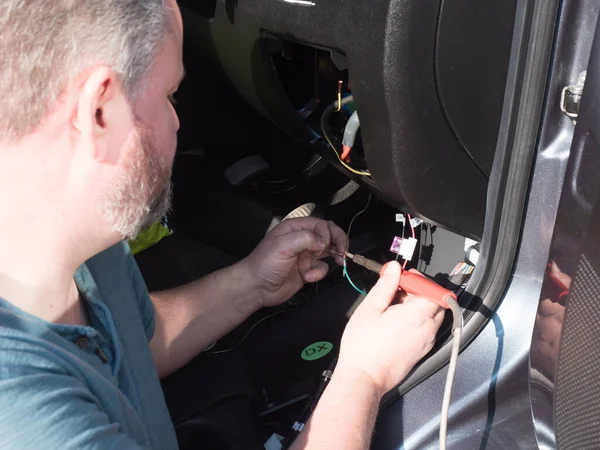 Bearded Male Mechanic Works Wiring Motorhome Recreational Vehicle Front Footwell Stock Picture