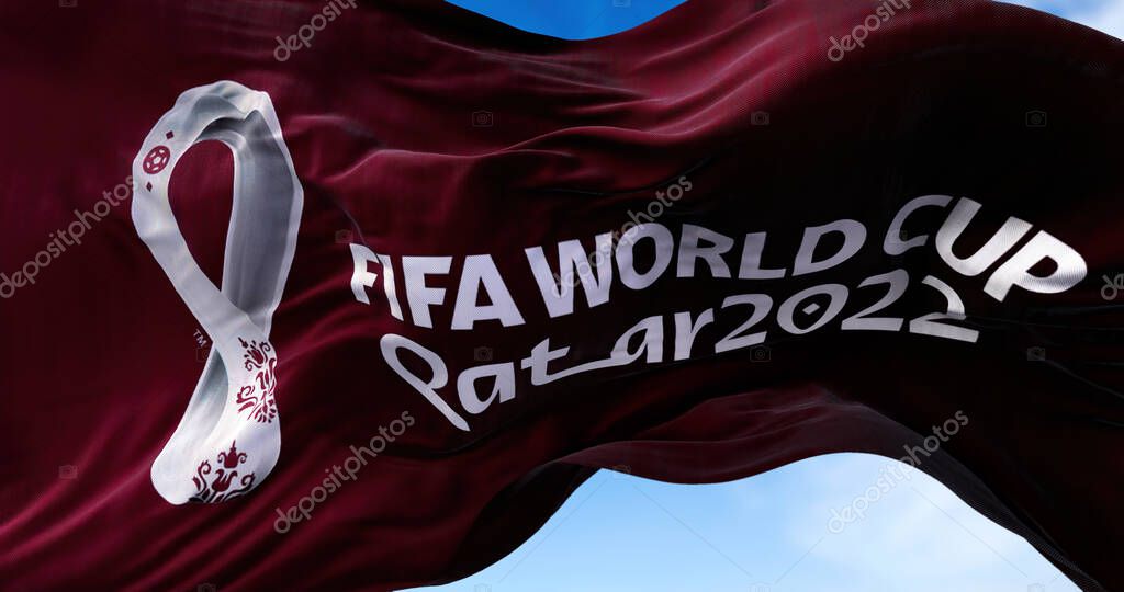 Doha, Qatar, October 2021: A flag with the 2022 Fifa World Cup logo flapping in the wind. The event is scheduled in Qatar from 21 November to 18 December 2022