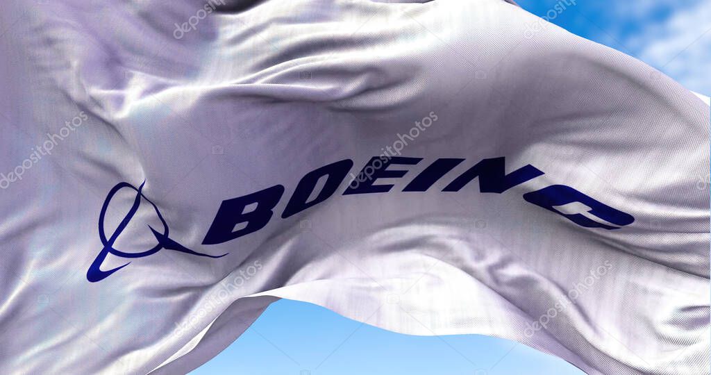 Chicago, IL, USA, july 2021: White flag with the Boeing logo waving in the wind. The Boeing Company is a US aviation industry producing aircraft for both civil and military use