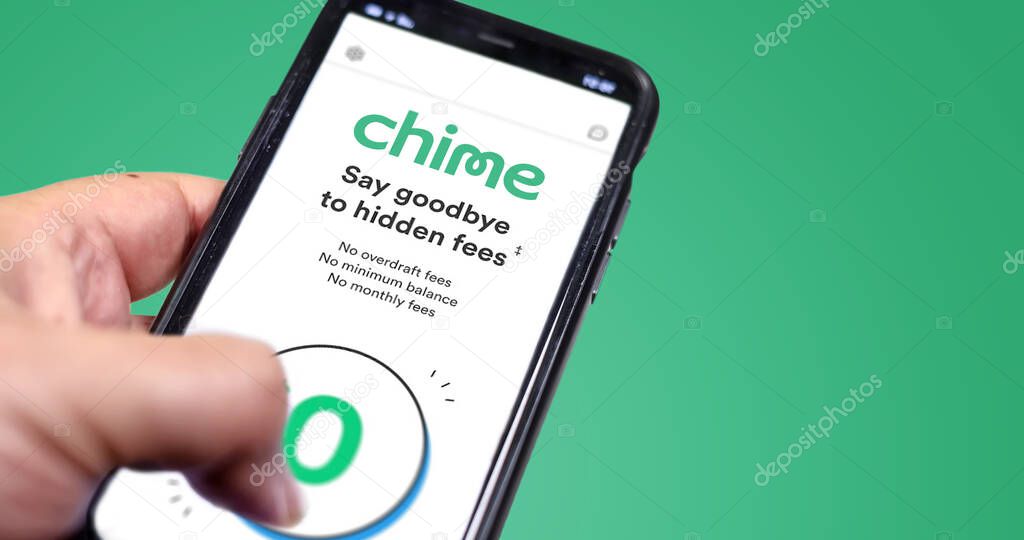 San Francisco, Ca, USA, December 2021: A hand holding a phone with the Chime app on the screen. Chime is an American financial technology company which provides fee-free mobile banking services