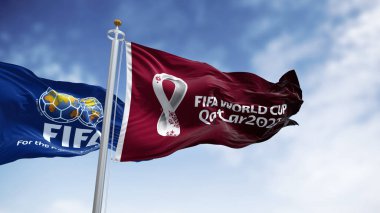 Doha, Katar, Ocak 2022: FIFA ve Katar 2022 Dünya Kupası logolu bayraklar rüzgarda sallanıyor. Etkinlik 21 Kasım - 18 Aralık 2022 tarihleri arasında Katar 'da gerçekleşecek.