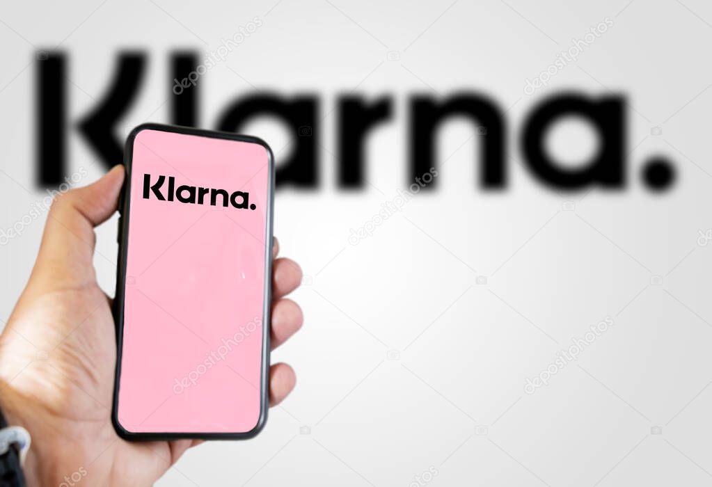 Rome, Italy, February 2022: Hand holding a device with the Klarna mobile app on the screen. Klarna is the largest private fin-tech start-up in Europe. Illustrative editorial