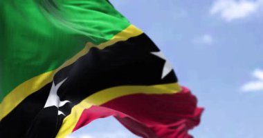 Aziz Kitts ve Nevis bayrağının açık havada rüzgarda sallanışının ayrıntıları. Saint Kitts ve Nevis, Batı Hint Adaları 'nda bir ada ülkesidir. Seçici odaklanma. Yavaş çekimde kusursuz döngü