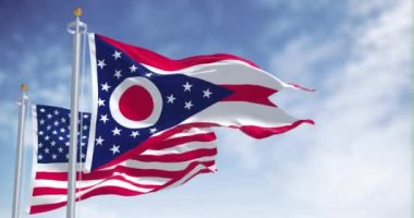 Ohio eyalet bayrağı, Amerika Birleşik Devletleri bayrağıyla birlikte dalgalanıyor. Arka planda açık bir gökyüzü var. Ohio, ABD 'nin orta batı bölgesinde bulunan bir eyalettir.