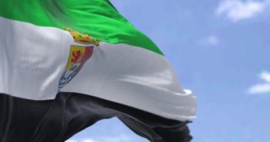Extremadura bayrağı açık bir günde rüzgarda dalgalanıyor. Extremadura İspanya 'nın özerk bir topluluğudur. Başkenti Merida 'dır. Yavaş çekimde kusursuz döngü