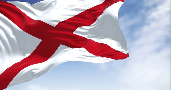 Close up of the Alabama state flag waving in the wind. Alabama is a state in the Southeastern region of the United States. Democracy and independence. American state.