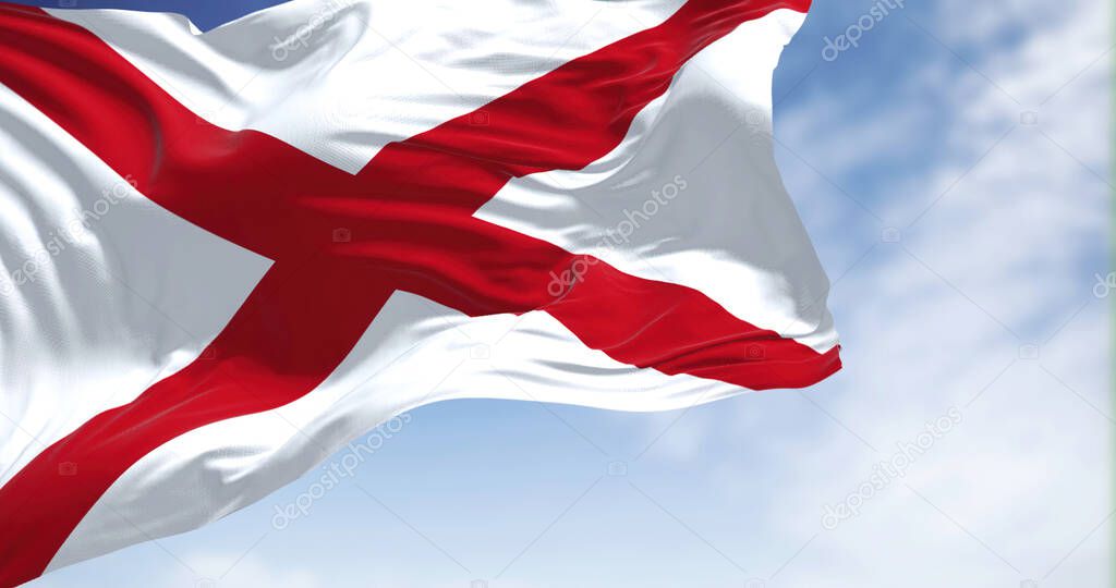 Close up of the Alabama state flag waving in the wind. Alabama is a state in the Southeastern region of the United States. Democracy and independence. American state.