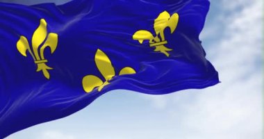 The flag of Ile de France region waving in the wind on a clear day. Ile de France is the most populous of the eighteen regions of France. Seamless loop in slow motion