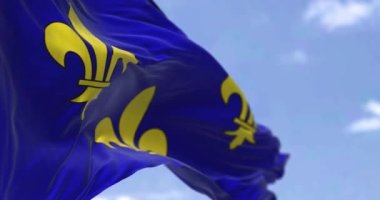 The flag of Ile de France region waving in the wind on a clear day. Ile de France is the most populous of the eighteen regions of France. Seamless loop in slow motion