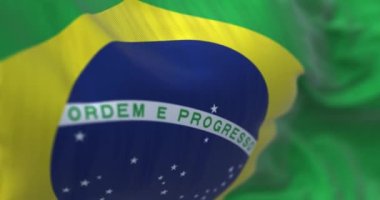 Close-up view of the Brazilian national flag waving in the wind. Brazil is a South American country. Fabric background. Seamless loop in slow motion