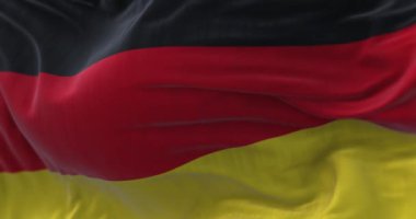 Rüzgarda dalgalanan Alman ulusal bayrağının yakın plan görüntüsü. Almanya bir Avrupa ülkesidir. Yavaş çekimde kusursuz döngü