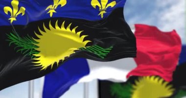 Guadeloupe 'un ulusal bayrakları açık bir günde Fransa bayrağını sallıyor. Guadeloupe, Fransa 'nın Karayipler bölgesinde bulunan bir takımada. Yavaş çekimde kusursuz döngü