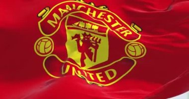 Manchester, UK, May 2022: The flag of Manchester United waving in the wind. Manchester United is a professional football club based in Manchester, England. Seamless loop in slow motion