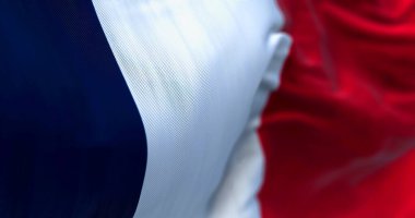 Close-up view of the France national flag waving in the wind. France is a country located in Western Europe. Fabric texture background. Selective focus