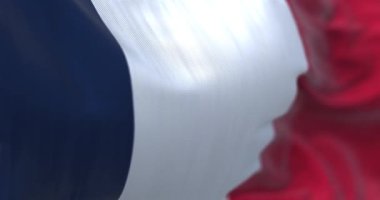 Close-up view of the France national flag waving in the wind. France is a country located in Western Europe. Fabric texture background. Selective focus. Seamless loop in slow motion
