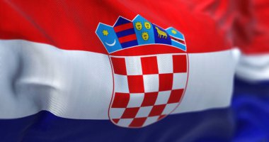 Close-up view of the Croatian national flag waving in the wind. Croatia is a country at the crossroads of Central and Southeast Europe. Fabric textured background. Selective focus